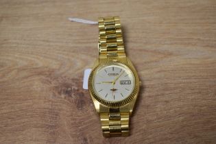 A Citizen Automatic 21 jewels wristwatch with stainless steel strap and champagne coloured face