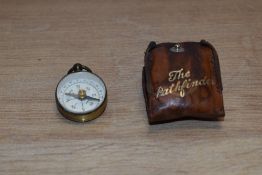 An early-mid 20th Century miniature 'The Pathfinder' magnetic compass, with leather case