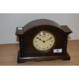 An early 20th century oak mantle clock, having an enamelled Arabic dial, 8 day Swiss movement, and