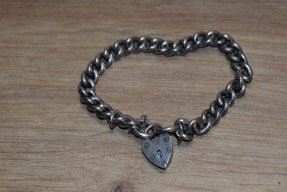 A silver curb link bracelet with padlock clasp, approx 26g