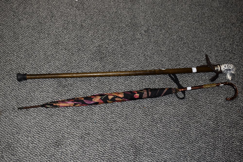 A vintage walking stick with dog's head handle, 88cm long, and a parasol