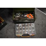 A green metal tool chest containing tools and a box of screws