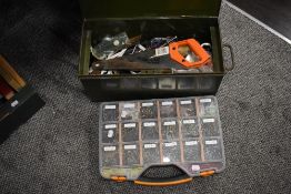 A green metal tool chest containing tools and a box of screws