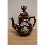 A Victorian barge ware, treacle glazed and having applied floral decoration, 30cm tall