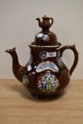 A Victorian barge ware, treacle glazed and having applied floral decoration, 30cm tall