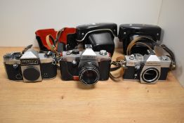 Three Praktica cameras. A Praktica Super TL body, a Praktica TL2 with Pentacon 1,8/50 lens and a