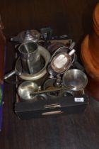 An assorted collection of silver plated ware, including tankards, sauce boats, and jugs