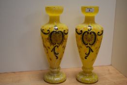 A pair of early 20th Century yellow Czech or Bohemian glass vases, with stylised hand painted