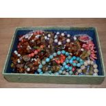 An assorted collection of coloured bead necklaces, nugget shaped bead necklaces, and wedding cake