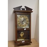 A mid-late 20th Century London Clock Company pendulum wall clock with weights, measuring 55cm tall