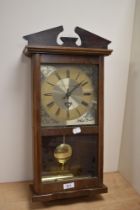 A mid-late 20th Century London Clock Company pendulum wall clock with weights, measuring 55cm tall