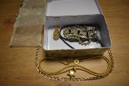 A tin of costume jewellery, including Sence Copenhagen star pendant and chain, plus other decorative