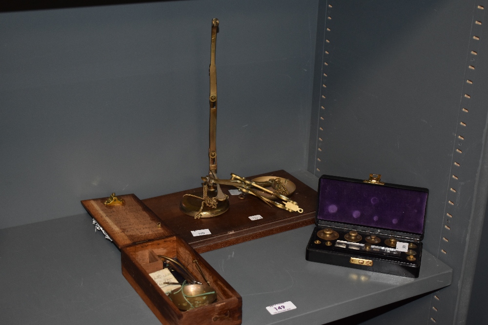 A set of late 19th/early 20th Century brass balance scales, together with two other sets of scales