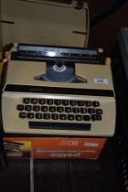 A 1970s Petite Super International typewriter with box