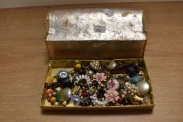 A box of assorted costume jewellery, including floral encrusted decorative brooches, and others