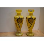 A pair of early 20th Century yellow Czech or Bohemian glass vases, with stylised hand painted