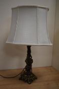 A Victorian gilt metal table lamp with shade, measuring 46cm tall