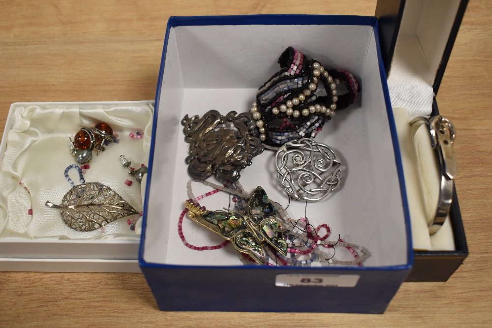 A collection of costume jewellery, including an iridescent enamelled butterfly brooch, a white metal