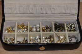 A black leather Rowallan jewellery box containing pearl style earrings, stud earrings, and others