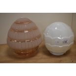 Two vintage lamp shades, including moulded opaque shade and pink frosted shade.