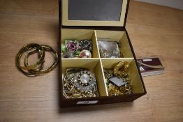 A box of miscellaneous costume jewellery, to include yellow metal bangles, an enamelled flower