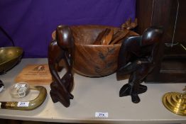 Two 20th Century African hardwood figural ornaments, measuring 23cm tall, a rustic hardwood salad