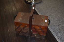 A vintage cantilever action sewing box with ebonised handles