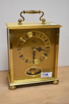 A brass 'Timemaster' mantel clock in German case.