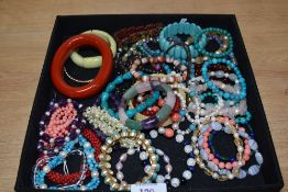 An assorted collection of coloured bead jewellery, including turquoise bracelets, a chunky coral