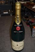 A large plastic Moet & Chandon shop display bottle, measuring 102cm tall