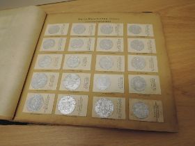 An early 20th century German GREILING MUNZ SAMMLUMG World Coin Cigarette Cards in original album,