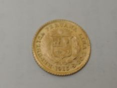 A Peru 1913 Gold 1/5 De Libra, shield one side with native head on other side