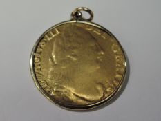 A 1782 George III Gold Guinea, shield back, in loose fitting yellow metal mount, possible 9ct but n