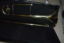 An unbranded trombone with hard case