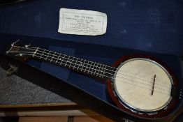 A vintage banjo ukulele, labelled Keech, with impressed marks and impressed signature to reverse