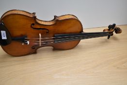 A late 19th or early 20th Century violin having 14inch two piece back , unlabelled, with bow and