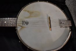 A Deering goodtime banjo, open back style, with Warwick rockbag and ply shipping case
