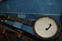 A vintage banjo ukulele, labelled to reverse of headstock for Clifford Essex