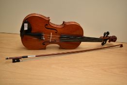 A traditional violin having 14inch two piece bag with figure head to scroll with bow and modern