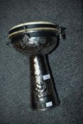 A traditional Djembe style goblet rum, having embossed chrome body