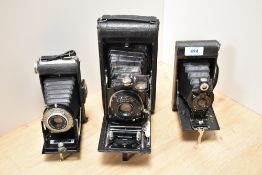 Three folding cameras. An Ensign by Houghton Ltd, a Kodak No2 Folding Autograph Brownie and a