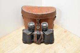 A pair of Heut Trinotix 8X30 binoculars in a leather case