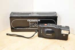 An Olympus XA camera with electric flash in original case