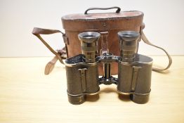 A pair of Dollond, London Prismatic X6 binoculars bearing military crowsfoot mark in leather case