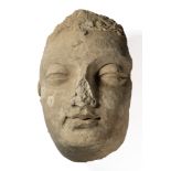 A LIFESIZE FRAGMENTARY GANDHARA STUCCO BUDDHA HEAD, NORTH-WESTERN PAKISTAN 4TH/5TH CENTURY