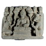 A GANDHARA GREY SCHIST RELIEF DEPICTING THE FIRST SERMON, NORTH-WESTERN PAKISTAN, 3RD/4TH CENTURY