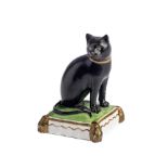 A ROCKINGHAM PORCELAIN FIGURE OF A CAT, CIRCA 1830