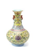 A CHINESE FINELY ENAMELLED FAMILLE-ROSE YELLOW-GROUND 'LOTUS' BOTTLE VASE, 20TH CENTURY