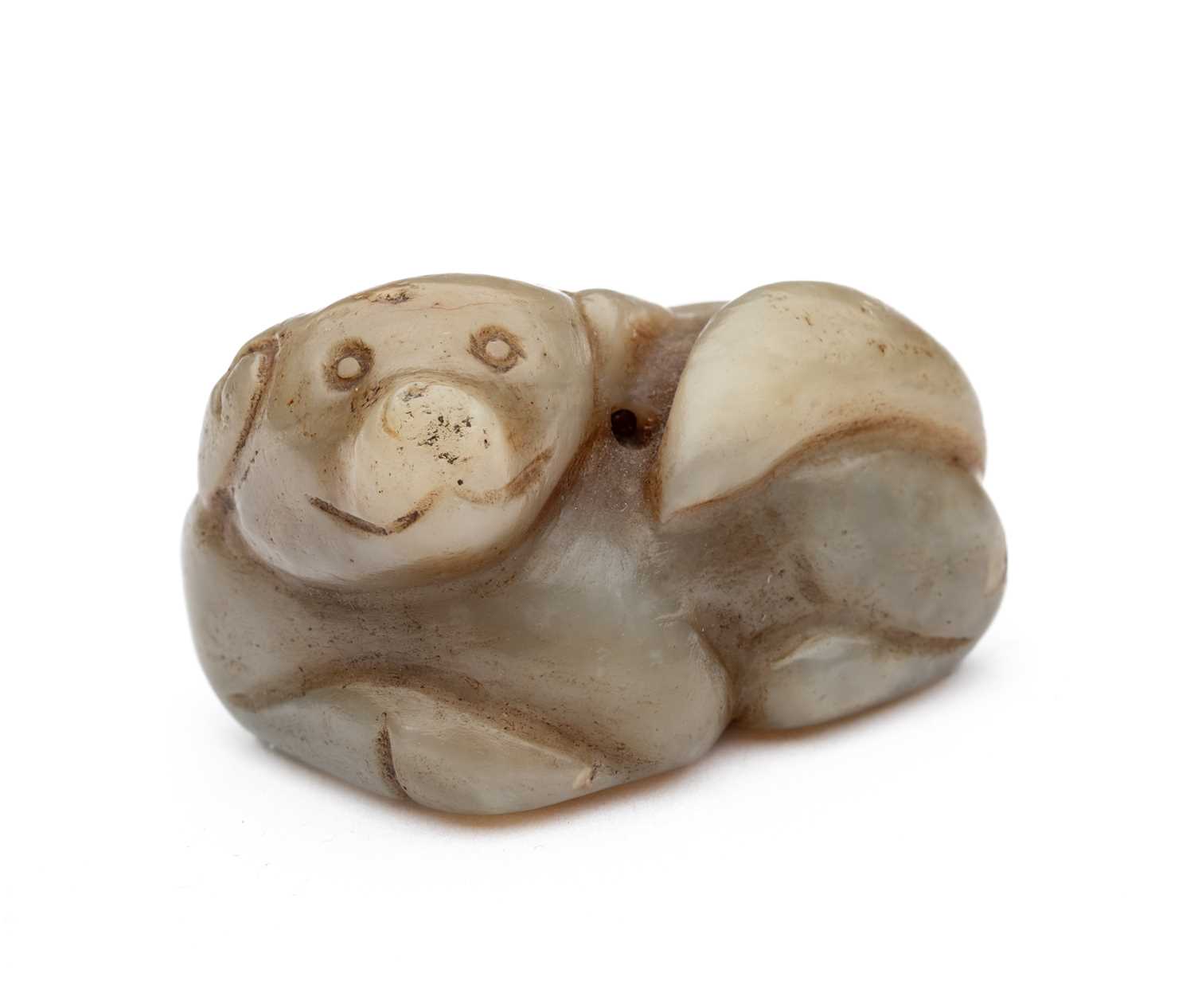 A CHINESE CELADON JADE DOG, QING DYNASTY (1644-1911)