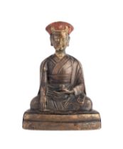 A BRONZE FIGURE OF A KARMAPA LAMA, TIBET, 19TH CENTURY OR EARLIER